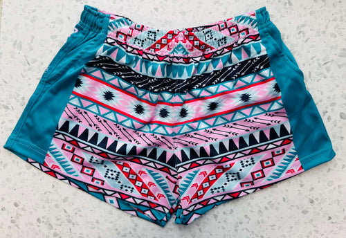 A pair of FOOTY SHORTS - AZTEC  WITH POCKETS with pockets and an elastic waistband