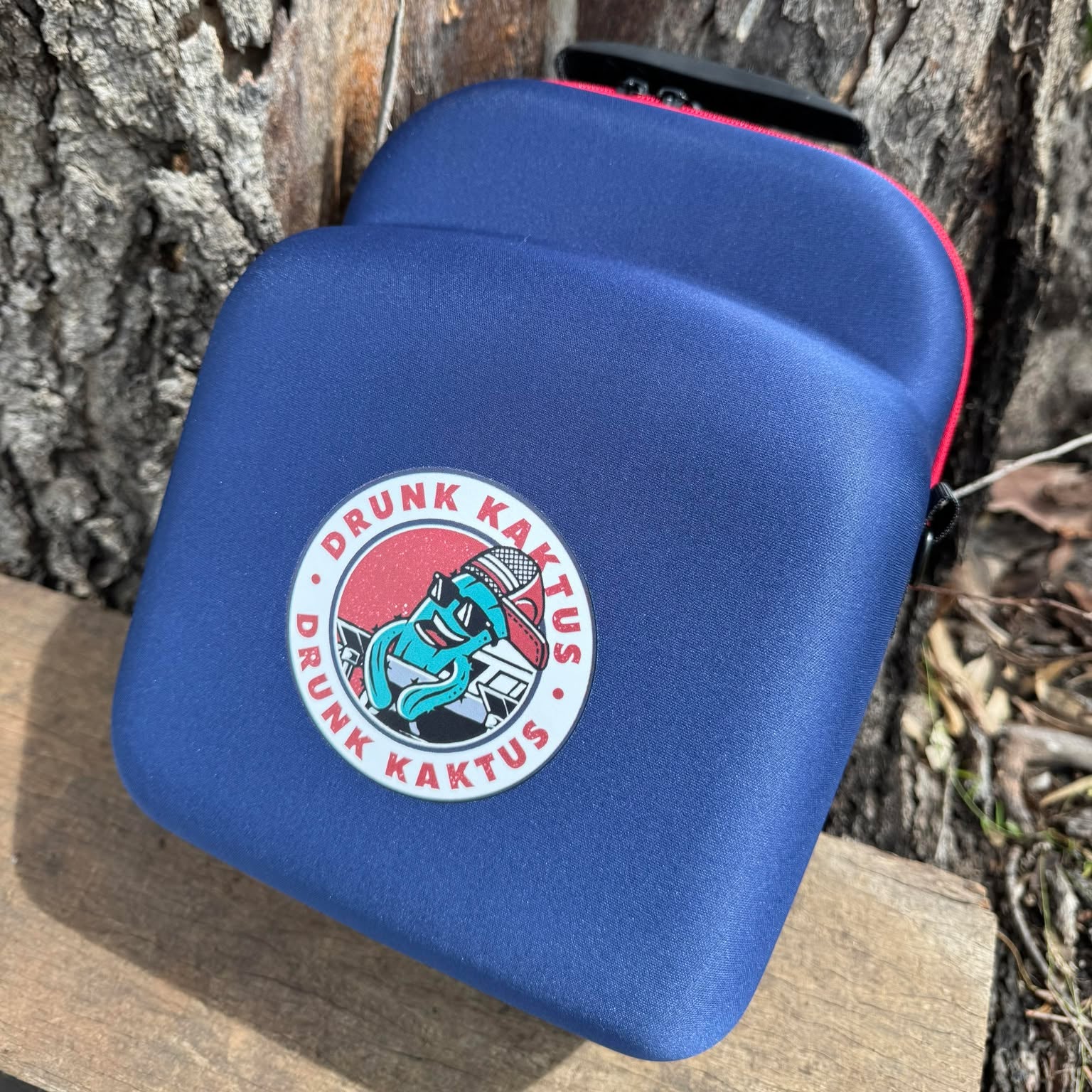 Open trucker cap case showing empty hard shell interior and zip closure