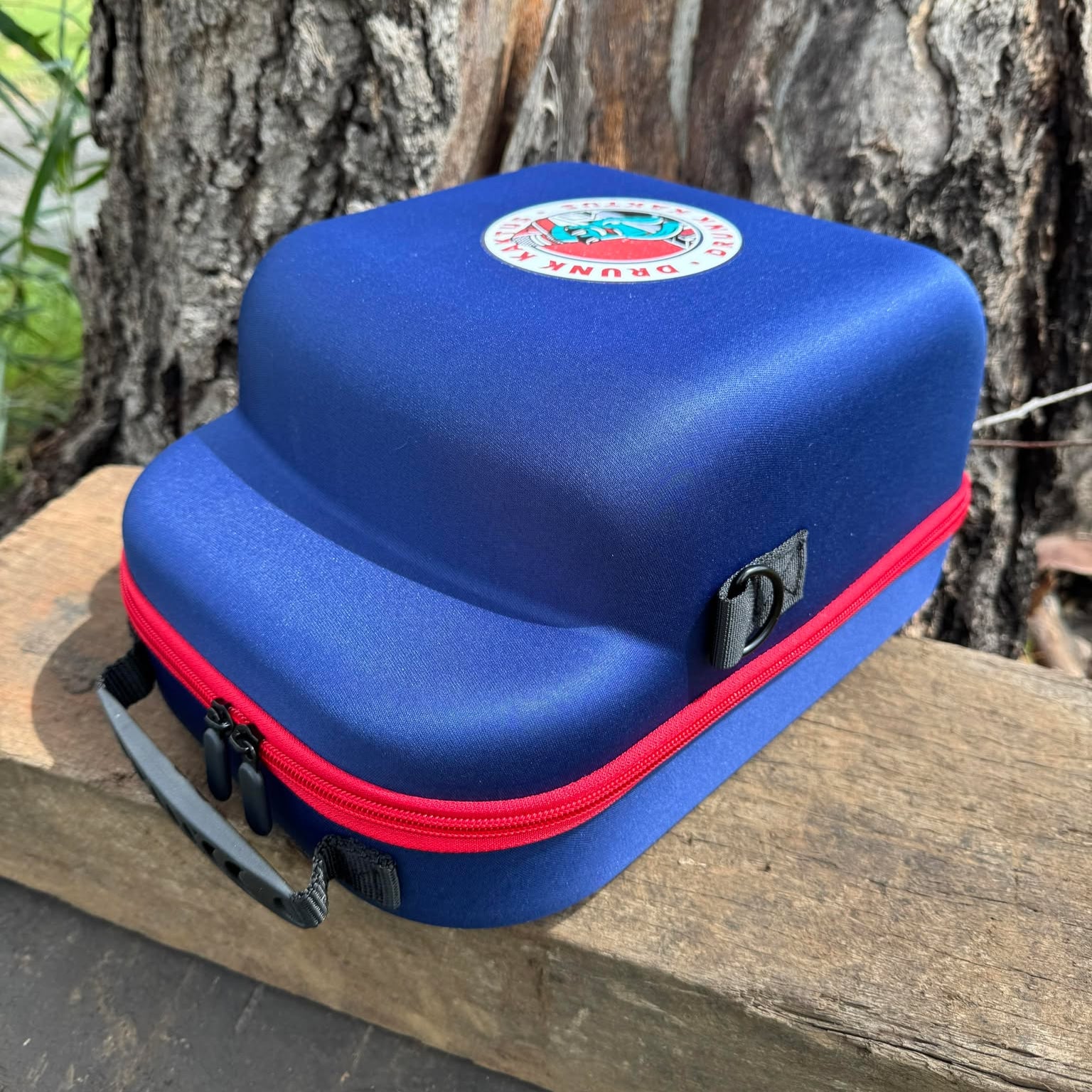 Trucker cap case with hard shell design and zip closure, shown from front