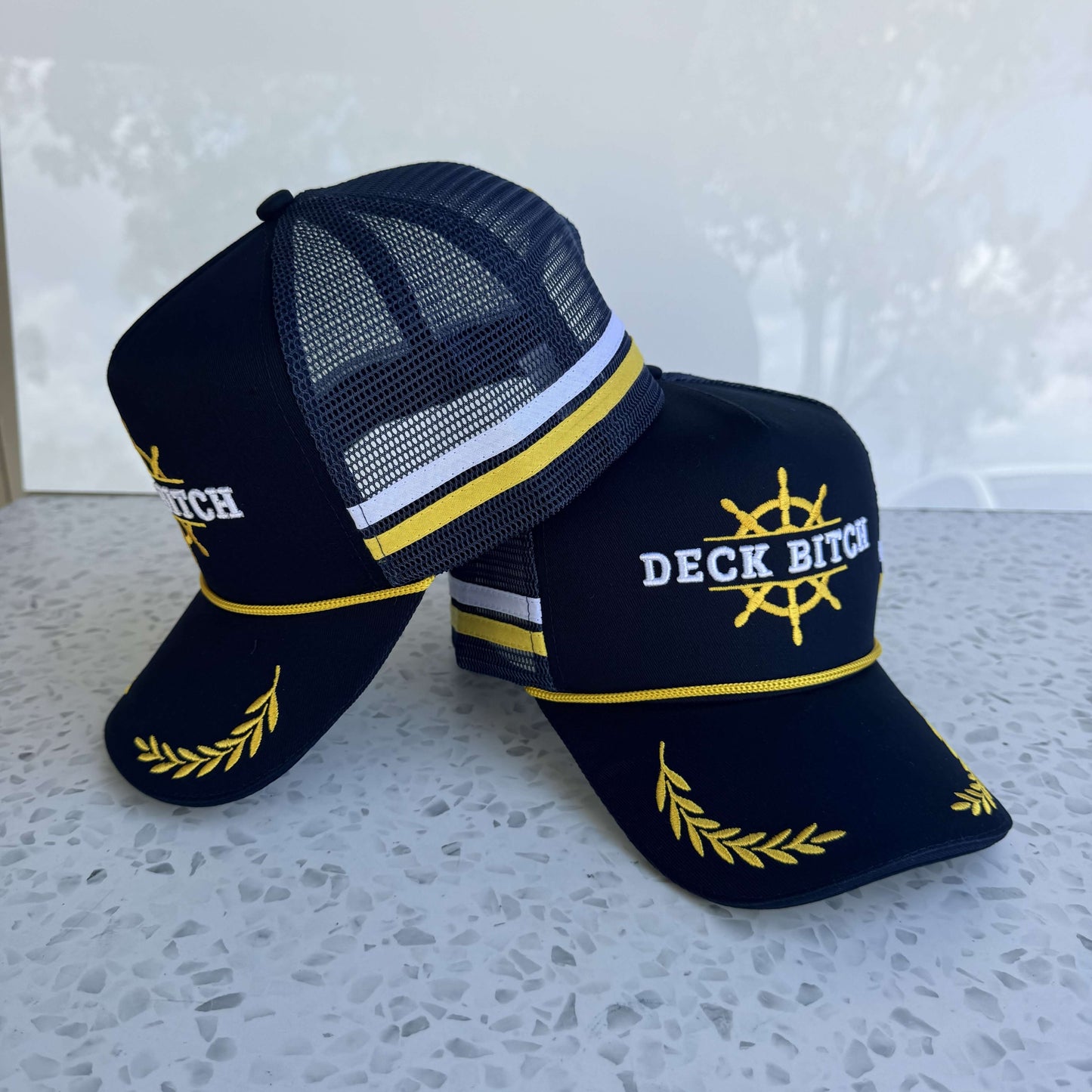 Deck Bitch - High Profile Trucker Cap in black cotton twill with breathable mesh back and snapback closure.