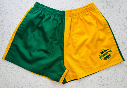 Green gold cotton shorts laid flat showing elastic waistband and drawstring