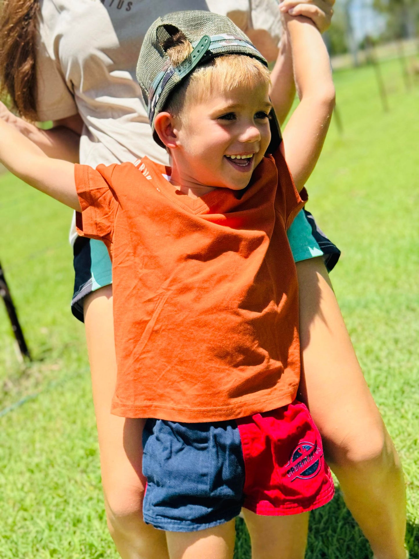 A kid with KIDS RUGGERS Navy red cotton drill shorts from RUGGERS, featuring comfortable design and durable fabric for everyday wear.