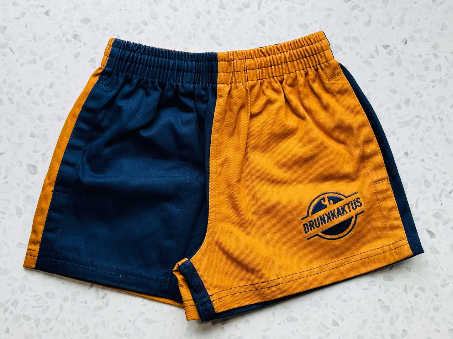 Kids Ruggers Navy Mustard Cotton Shorts for active kids featuring a durable and stylish two-tone design.
