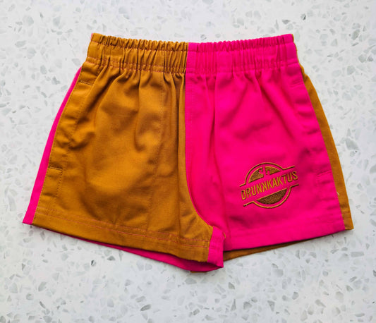 Front view of kids mustard pink ruggers cotton drill shorts with elastic waistband and drawstring.