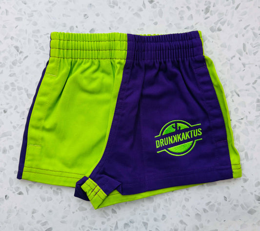 Close-up of kids green purple ruggers cotton drill shorts showcasing the two-tone fabric texture and stitching details.