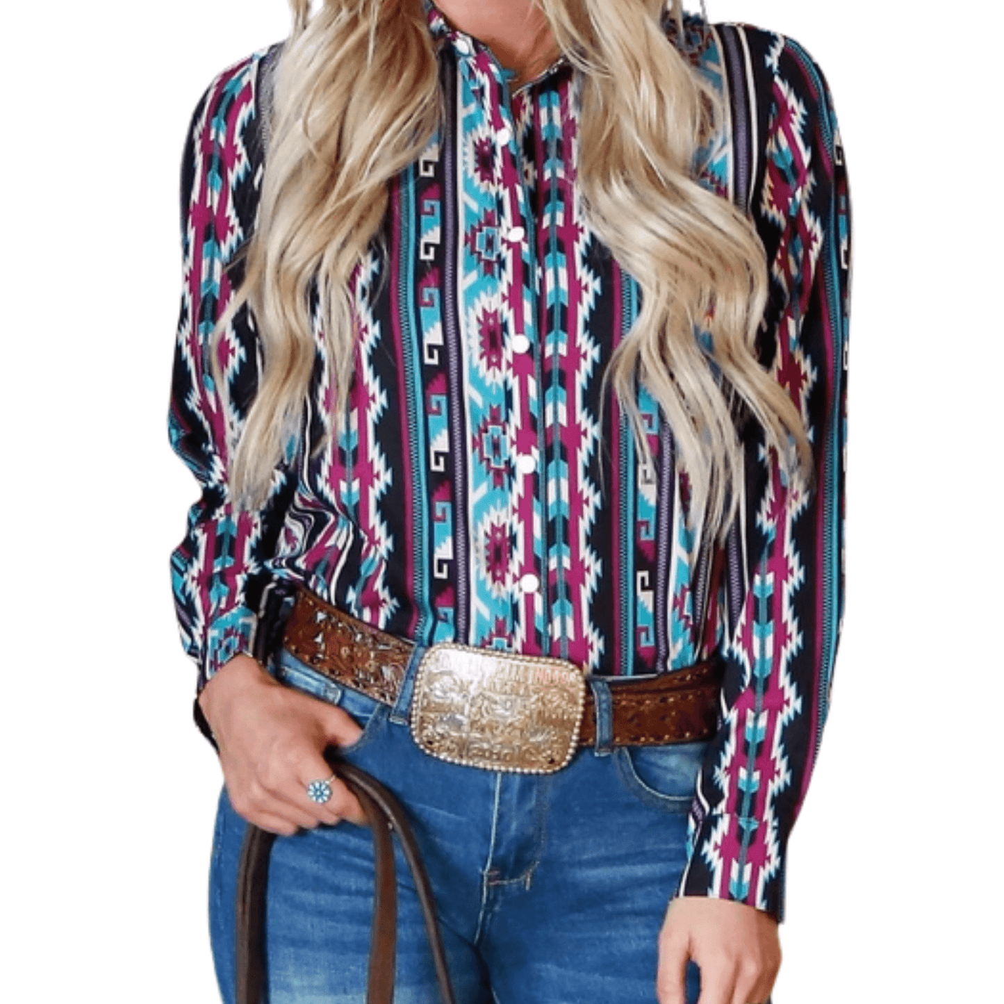A woman wearing a Southern Soul Aztec Western Shirt Cowgirl Rodeo Style with a vibrant turquoise and purple Aztec pattern, tucked into blue jeans with a wide brown belt and a large gold rodeo-style buckle, holding a leather strap.