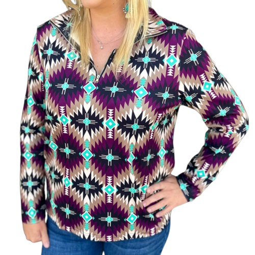A woman wearing a vibrant Southwestern Aztec Pullover Sweatshirt with a mix of purple, black and blue colors, paired with blue jeans.