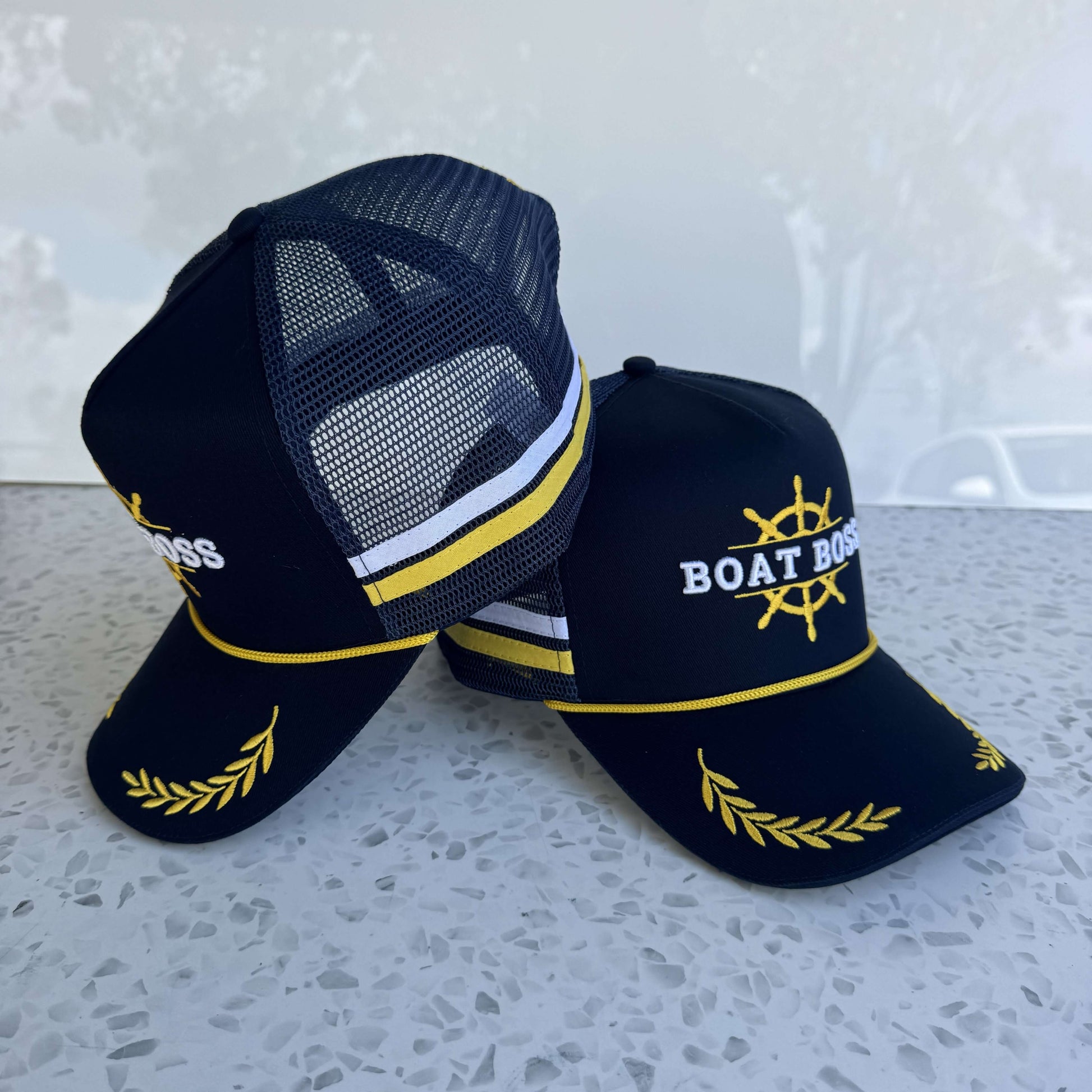 Description: Elevate your style with the Boat Boss - High Profile Trucker Cap. Features a structured cotton twill front, breathable mesh, and an adjustable 59cm snapback