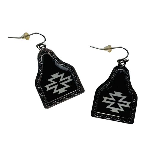 A pair of black earrings with white geometric patterns