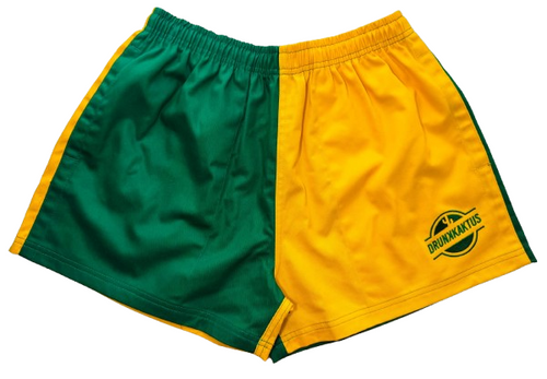 Green gold cotton shorts laid flat showing elastic waistband and drunk kaktus logo