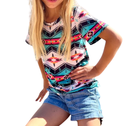Child wearing a short sleeved, brightly patterned Southwestern Kids Top with geometric and tribal inspired design.