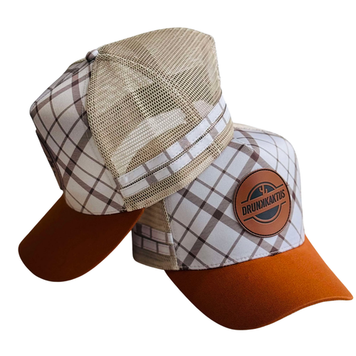 Two trucker caps placed one in front of the other. The first cap has a beige checkered pattern with a brown visor, and the second cap has a brown checkered pattern with a beige visor.